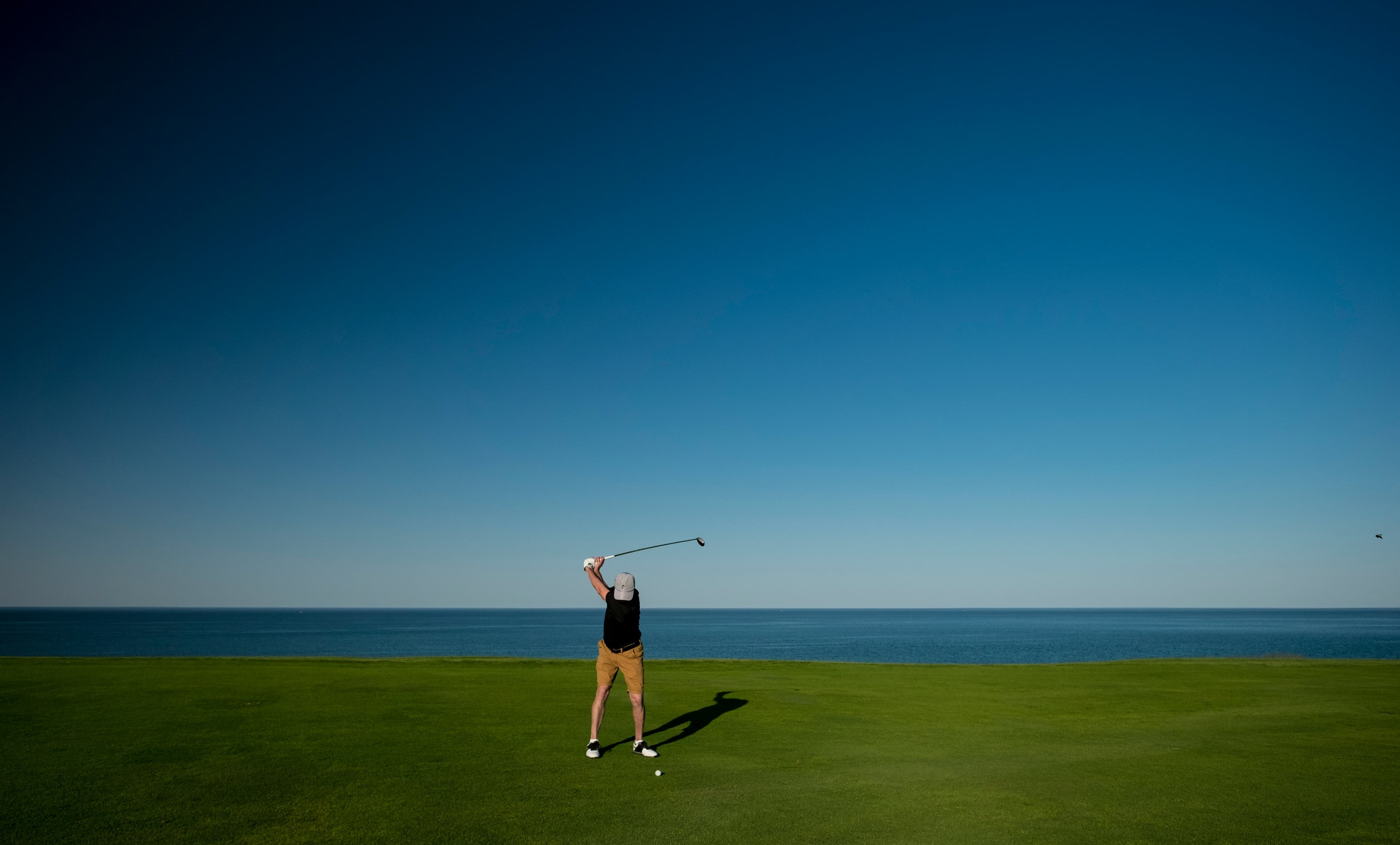 Golfer hitting a shot on a coastal golf course in the Tampa Bay area